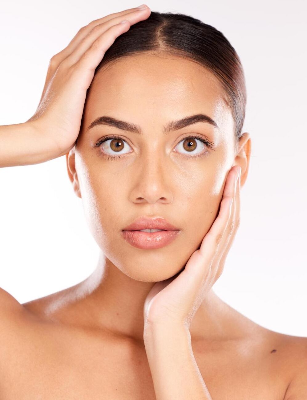 a young woman with smooth clear and firm skin holding her face