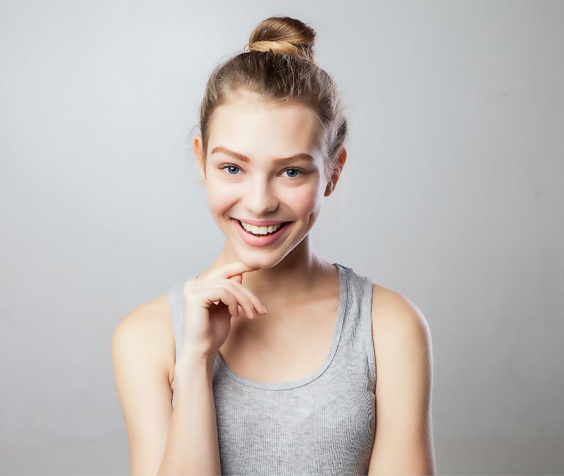 woman smiling posing with defined and young looking face