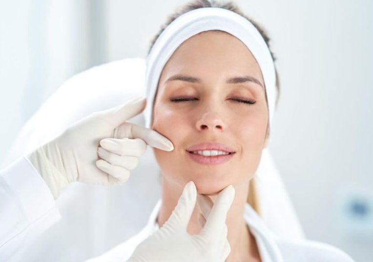 Woman at cosmetic clinic getting examined by doctor to treat fine lines near the mouth