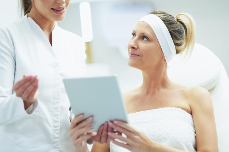 A middle aged woman receiving advice from cosmetic doctor on treating wrinkles at clinic